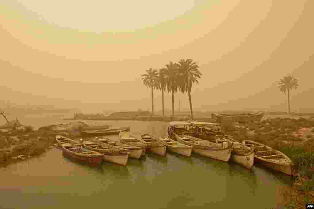 A sandstorm clouds the air and leaves boats covered in grit in Iraq's southern city of Basra.