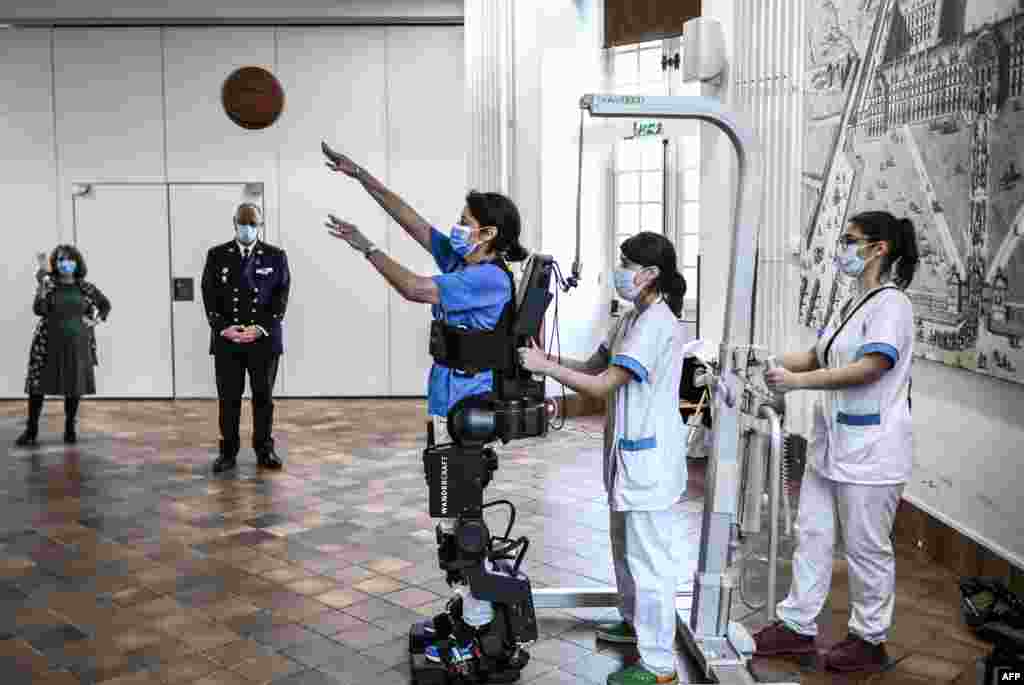 A doctor experiences an exoskeleton during a demonstration at the Invalides hospital in Paris, France, Nov. 9, 2022.