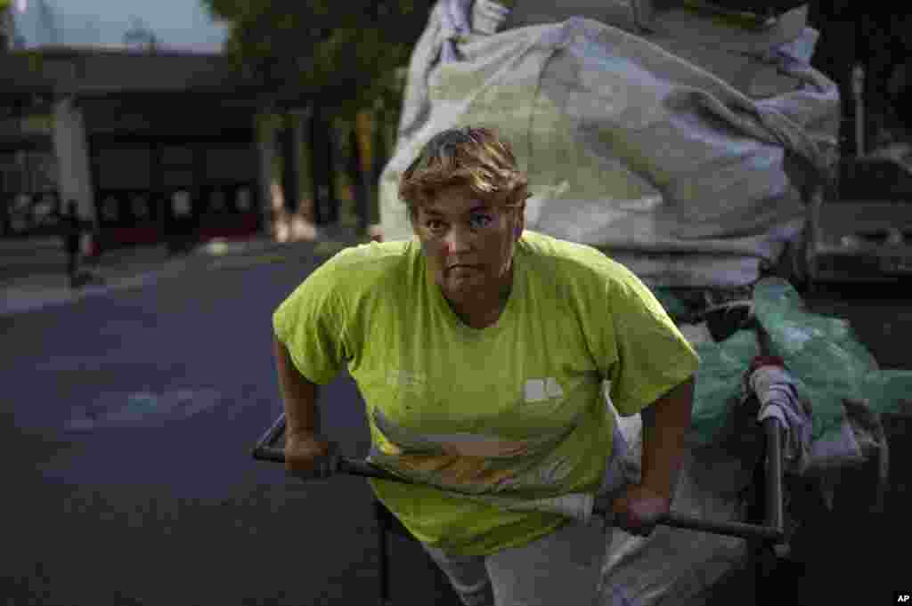 Noemi del Valle pushes a cart of recyclable items in Buenos Aires, Argentina.