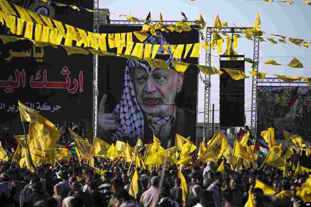 Palestinians chant slogans and wave yellow Fatah movement flags during a rally marking the 18th anniversary of the death of Fatah founder and Palestinian Authority leader Yasser Arafat in Gaza City.