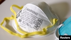 FILE PHOTO: Various N95 respiration masks at a laboratory of 3M, that has been contracted by the U.S. government to produce extra marks in response to the country's novel coronavirus outbreak, in Maplewood, Minnesota, U.S. March 4, 2020. Picture…