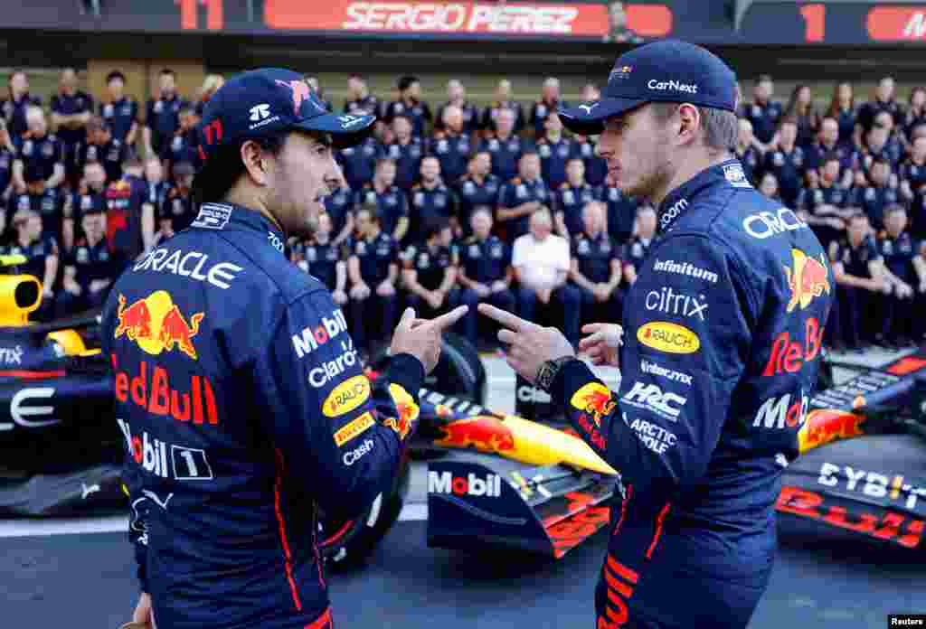 Red Bull's Mexican driver Sergio Perez and Red Bull's Dutch driver Max Verstappen chat before a team photo shoot ahead of the Abu Dhabi Formula One Grand Prix at the Yas Marina Circuit in the Emirati city of Abu Dhabi.