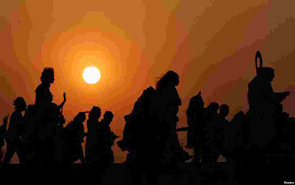 General view of a silhouette of fans outside the stadium before the match between Qatar and Ecuador during the FIFA World Cup at the Al Bayt Stadium in Al Khor, Qatar.
