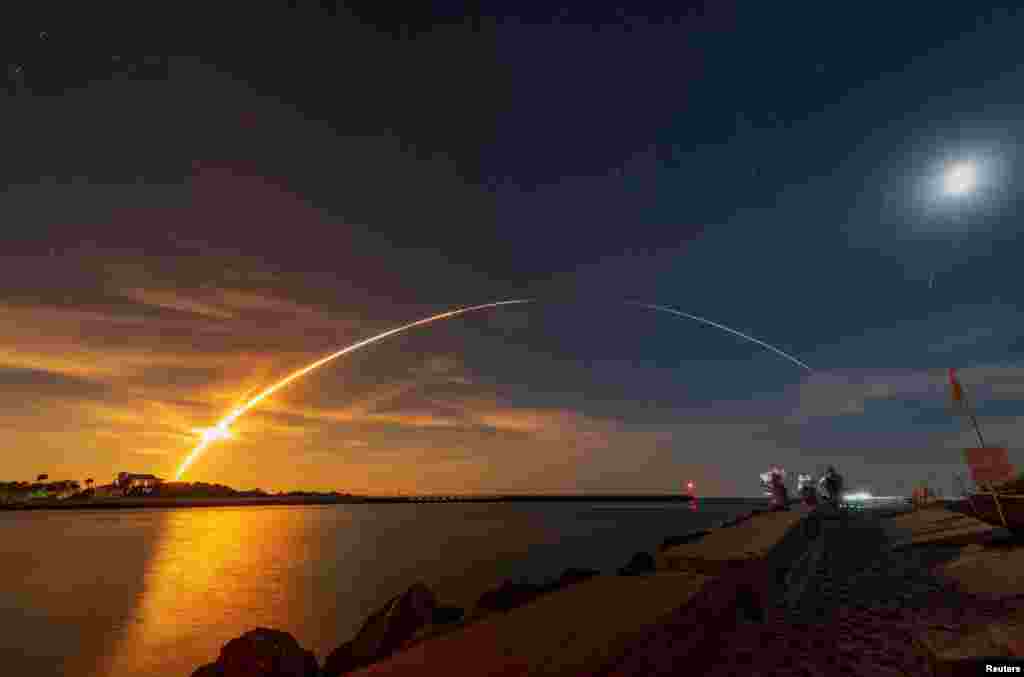 NASA's next-generation moon rocket, the Space Launch System (SLS) rocket with the Orion crew capsule, lifts off from launch complex 39-B on the unmanned Artemis 1 mission to the moon, seen from Sebastian, Florida.