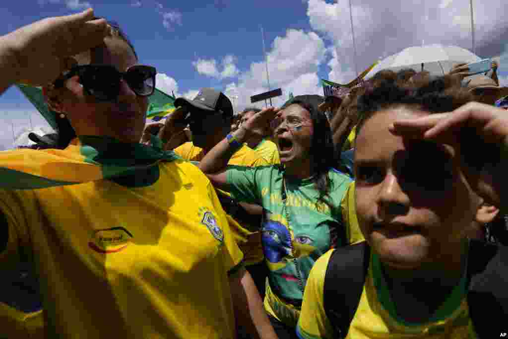 Supporters of Brazilian President Jair Bolsonaro salute and sing their national anthem during a protest against Bolsonaro's run-off election loss outside the Army headquarters in Brasilia, Brazil.
