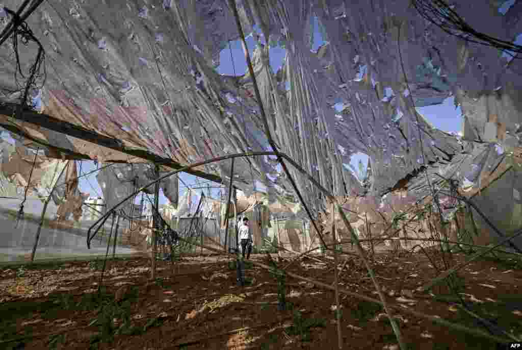 A Palestinian man inspects damage caused by an early morning Israeli airstrike in the Maghazi refugee camp in the central Gaza Strip.