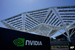 FILE - A Nvidia Corp. sign is shown in Santa Clara, Calif., May 31, 2023. AI chips and their leading designer, Nvidia, are now at the center of what some experts consider an AI revolution that could reshape the technology sector.