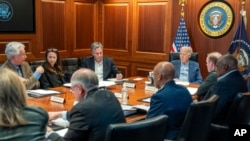 FILE - In this image provided by the White House, President Joe Biden, along with members of his national security team, receive an update in the Situation Room of the White House, April 13, 2024. 