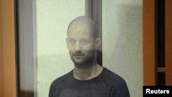Wall Street Journal reporter Evan Gershkovich stands inside an enclosure for defendants as he attends a court hearing in Yekaterinburg, Russia, July 19, 2024. 