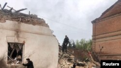 Police officers work at a site of a local museum heavily damaged by a Russian missile strike in the town of Kupiansk, Kharkiv region, Apr. 25, 2023. (Press service of the National Police of Ukraine in Kharkiv region/Handout via Reuters) 