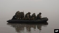 FILE - Ukrainian marines sail along the Dnipro river at the front line near Kherson, Ukraine, Oct. 14, 2023. 