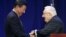 FILE - Chinese President Xi Jinping, left, shakes hands with former U.S. National Security Adviser and Secretary of State Henry Kissinger in Seattle, Washington, Sept. 22, 2015.