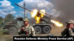 FILE - Russian soldiers fire from a BM-21 "Grad" self-propelled 122mm multiple rocket launcher at an undisclosed location in Ukraine, July 1, 2024.