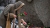 A woman pays tribute to Alexey Navalny at the monument where the first camp of the Gulag political prison system was established in St. Petersburg, Russia, Feb. 21, 2024. Navalny, the most famous Russian opposition leader, died in prison Feb. 16, at 47.