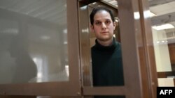 Amerčki novinar Evan Gerškovič, uhapšen pod optužbama za špijunažu, gleda iz kaveza za optuženike pre početka saslušanja po njegovoj žalbi, tokom predkaznenog pritvora, u Moskovskom gradskom sudu, 20. februara 2024. (Foto: AFP/Natalia Kolesnikova)
