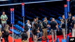 Security agents prepare for a sweep of the Fiserv Forum ahead of the 2024 Republican National Convention, July 13, 2024, in Milwaukee.