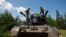 Ukrainian servicemen speak to each other atop a Gepard self-propelled anti-aircraft gun during their combat shift, amid Russia's attack on Ukraine, in Kyiv region, Ukraine June 30, 2023.