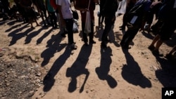 FILE - Migrants wait to be processed by U.S. Customs and Border Protection after they crossed the Rio Grande and entered the U.S. from Mexico, in Eagle Pass, Texas, Oct. 19, 2023. 
