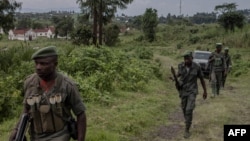 Waasi wa kundi la M23 wakati wa mkutano kati ya maafisa wa Kikosi cha Afrika Mashariki (EACRF) na waasi wa M23 katika kambi ya Rumangabo huko DRC Januari 6, 2023. Picha na Guerchom Ndebo/AFP