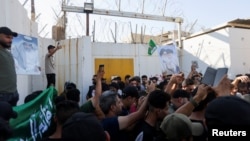 Protesters gather at the entrance to the Swedish embassy in Baghdad, Iraq, a day after a man tore up and burned a copy of the Quran outside a mosque in the Swedish capital Stockholm, Iraq, June 29, 2023.