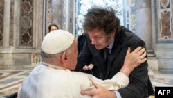 This handout photograph taken on Feb. 11, 2024 and released by the Vatican press office, Vatican Media, shows Pope Francis (L) greeting Argentine President Javier Milei (R) at the Vatican. (Photo by Handout / Vatican Media / AFP)