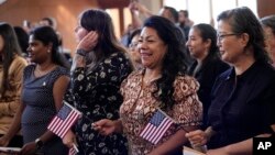 FILE - Women representing more than 20 countries take part in a Naturalization Ceremony, in San Antonio, March 8, 2024. The U.S. immigrant population from South and Central Asia is climbing.