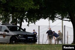 A member of the FBI Evidence Response Team works near the building where a gunman was shot dead by law enforcement in Butler, Pennsylvania, July 15, 2024.