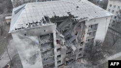 This handout picture from the Ukrainian Emergency Service on Feb. 21, 2024 shows a damaged building, where four residents were wounded, after a night attack to Pokrovsk district, Donetsk region. (Photo by Handout/Ukrainian Emergency Service via AFP) 
