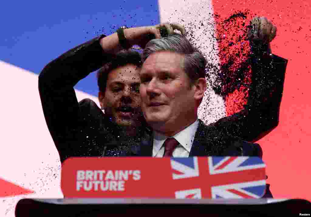 A protester throws confetti on Britain's Labour Party Leader Keir Starmer at the party's annual conference in Liverpool. REUTERS/Phil Noble