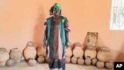 FILE - Mariama Sonko poses in the seed hut of her agro-ecological training center in the Casamance village of Niaguis, Senegal, March 7, 2024.