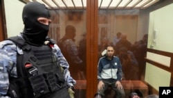FILE - Saidakrami Murodali Rachabalizoda, a suspect in the Crocus City Hall shooting, sits in a Moscow courtroom, March 24, 2024. The attack on the hall appears to be setting the stage for an increasingly harsh response by President Vladimir Putin.