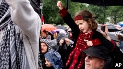 A 7-year-old from the U.S. state of Virginia sits on the shoulders of her grandfather, who is Palestinian, during a pro-Palestinian rally near the U.S. Capitol in Washington, May 18, 2024.