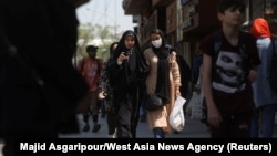 Iranian women walk on a street amid the implementation of the hijab surveillance in Tehran, Iran, April 15, 2023. Majid Asgaripour/West Asia News Agency via Reuters