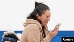 FILE - Liat Beinin, 49, an Israeli American, speaks with family, Nov. 29, 2023, having just been freed from Hamas captivity. Two Palestinian American families' lawsuit says the U.S. has not done as much to evacuate their U.S. relatives as it did for Israeli dual nationals.