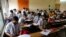 FILE - Students wearing face masks as a precaution against the coronavirus attend classes in Ahmedabad, India, Sept. 1, 2021. 
