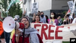 FILE - Jawahir Kamal leads pro-Palestinian demonstrators in a chant as they gather before a presidential debate between U.S. President Joe Biden and former President Donald Trump in Atlanta, Georgia, on June 27, 2024.