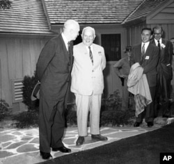 FILE - President Dwight D. Eisenhower and Soviet Premier Nikita Khrushchev pose for photos outside Camp David's main lodge on Sept. 25, 1959, in Thurmont, Md.