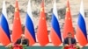 Chinese President Xi Jinping, right, and Russian President Vladimir Putin attend a signing ceremony following their talks in Beijing, China, on May 16, 2024. 