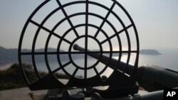 An antiquated 40mm anti-air gun points towards sea at the observation deck on Beigan, part of Matsu Islands, Taiwan on Sunday, March 5, 2023. (AP Photo/Johnson Lai)