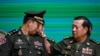 General Hun Manet (L), Commander of the Royal Cambodian Army and eldest son of Prime Minister Hun Sen, reacts as General Eth Sarath (R) touches the four stars on his shoulders during a promotion ceremony in Phnom Penh on April 20, 2023. 