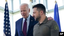 U.S. President Joe Biden walks with Ukrainian President Volodymyr Zelenskyy ahead of a working session on Ukraine during the G-7 Summit in Hiroshima, Japan, May 21, 2023.