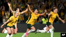 Australia's, from left, Ellie Carpenter, Caitlin Foord, Sam Kerr and Steph Catley celebrate after Cortnee Vine kicked the winning penalty goal to defeat France in the Women's World Cup quarterfinal soccer match between Australia and France in Brisbane, Australia, Aug.12, 2023. 