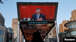 A giant screen shows news footage of Chinese President Xi Jinping attending the third plenary session of the 20th Central Committee of the Communist Party of China (CPC), in Beijing, July 18, 2024. 