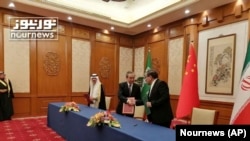 2023年3月10日，伊朗最高国家安全委员会秘书阿里·沙姆哈尼（右）在北京的会谈结束后同中共中央政治局委员、中央外办主任王毅握手。照片最左边是沙特国务大臣、内阁成员和国家安全顾问穆萨伊德·本·穆罕默德·艾班。