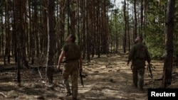 Ukrainian servicemen of the 93rd Separate Mechanized Brigade 'Kholodnyi Yar' look into the sky for Russian drones at a position near a frontline, amid Russia's attack on Ukraine, in Donetsk region, Ukraine, March 31, 2024. 