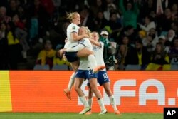 England's Alessia Russo, center, celebrates after scoring her side's 2nd goal during the Women's World Cup quarterfinal soccer match between England and Colombia at Stadium Australia in Sydney, Australia, Aug. 12, 2023.