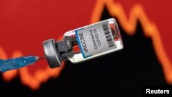 FILE - A vial labelled "VACCINE Coronavirus COVID-19" is seen in front of a stock graph in this illustration taken on January 17, 2022. (REUTERS/Dado Ruvic/Illustration)