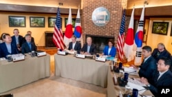 President Joe Biden, center, Japan's Prime Minister Fumio Kishida, right, and South Korea's President Yoon Suk Yeol, left, meet on Aug. 18, 2023, at Camp David. Surrounding Biden are Secretary of State Antony Blinken and Commerce Secretary Gina Raimondo.