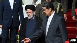 Iranian President Ebrahim Raisi, left, is welcomed by Venezuelan President Nicolas Maduro at Miraflores Presidential Palace in Caracas, June 12, 2023.