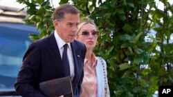 FILE - Hunter Biden, left, arrives with his wife, Melissa Cohen Biden, at federal court in Wilmington, Delaware, June 4, 2024.